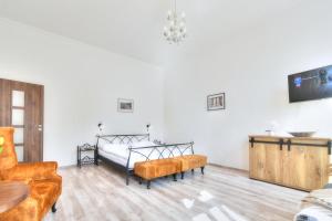 a bedroom with a bed and two chairs at Karlsbad Holiday in Karlovy Vary