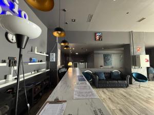 a living room with a long table and a couch at Rio Hostel in Madrid