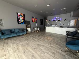 a waiting room with blue couches and a store at Rio Hostel in Madrid
