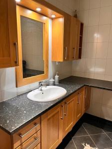a bathroom counter with a sink and a mirror at Cozy house with sea view close to Ålesund in Ålesund +19 photos