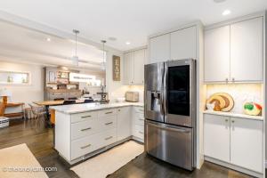 a kitchen with white cabinets and a stainless steel refrigerator at Couple's Oasis at Horner Park in Victoria
