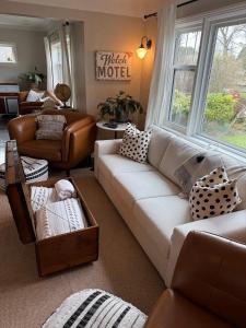 a living room with a white couch and a chair at Couple's Oasis at Horner Park in Victoria