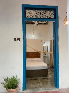 a door leading into a bedroom with a bed at Villa Mediterranea in Campeche