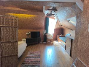 a room with a bed and a couch and a tv at Aveiro Train Studios in Aveiro