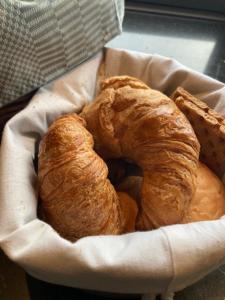two croissants in a basket on a table at Yurt Klyndobbe in Veenwoudsterwal
