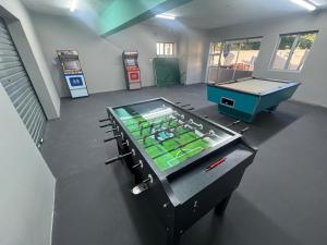 a room with a ping pong table and a pool table at Durban Holiday Apartments by Mieli Estates , Unit 6 in Durban