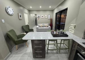 a kitchen and living room with a table and chairs at Durban Holiday Apartments by Mieli Estates , Unit 6 in Durban
