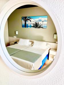 Postel nebo postele na pokoji v ubytování Hotel Neptuno