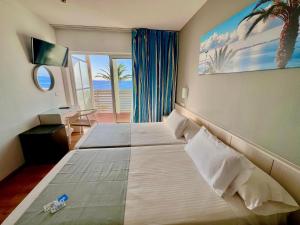 Postel nebo postele na pokoji v ubytování Hotel Neptuno