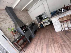 a living room with a fireplace and a table and chairs at Hostel Dourado in Barra do Garças