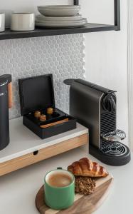 a counter with a coffee maker and a plate of food at Graudenz - Cozy Apartments in Karlovy Vary +33 photos