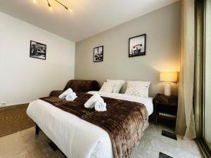 a bedroom with two beds with towels on them at Villa Estérel Large Studio with Terrace in Cannes +9 photos