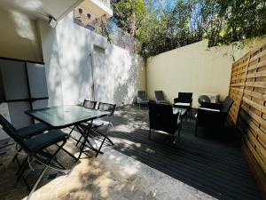 a patio with a table and chairs and a wall at Villa Estérel Large Studio with Terrace in Cannes