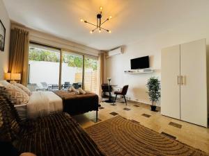 a bedroom with a bed and a living room at Villa Estérel Large Studio with Terrace in Cannes
