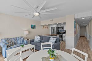 a living room with a couch and a table at Paradise Towers #104 in Carolina Beach