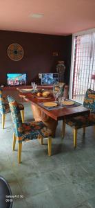 a wooden table with chairs and a dining room at Espaço do Mar in Olinda