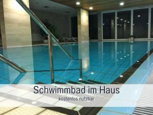 a swimming pool in a building with the words seymmed in has at Strandloft Cuxhaven im Haus Frauenpreiß Sahlenburg - strandnah - 2 Hunde willkommen -Schwimmbad - Sauna - direkt am Wald - Dachterrasse mit Blick nach Neuwerk in Cuxhaven