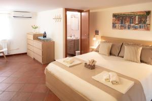 a bedroom with a large bed with towels on it at Luna Prime Collection Catania in Catania
