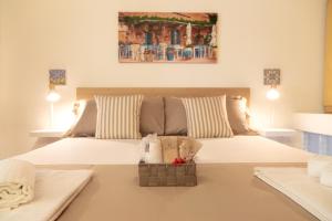 a bedroom with a large white bed with two pillows at Luna Prime Collection Catania in Catania