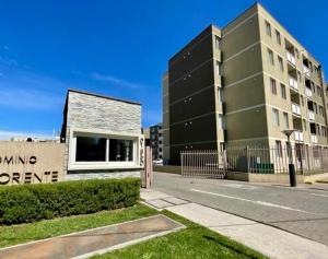 a building with a sign in front of a building at Amplio departamento in Temuco