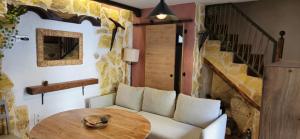 a living room with a white couch and a wooden table at mirador de la sierra in Cazorla