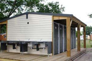 a large white shed with a black roof on a wooden deck at Cocooning Tipi - Azur in Azur +39 photos