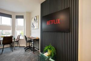 an office with a netflix sign on a wall at Entire Luxurious 2 Bedroom Flat in Leicester