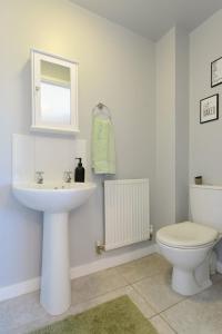 ein Badezimmer mit einem weißen Waschbecken und einer Toilette in der Unterkunft Home Private Parking, Sleeps 8, Contractors Welcome in Lemington + 22 Fotos