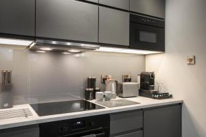 a kitchen with a sink and a counter top at Entire Luxurious 2 Bedroom Flat in Leicester