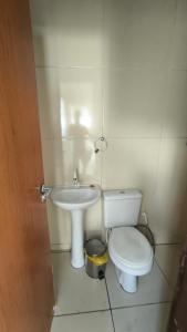 a bathroom with a toilet and a sink at CasanapraiadoFrancês25 in Marechal Deodoro +8 photos