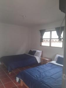 Postel nebo postele na pokoji v ubytování Hotel Mahoma