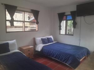 Postel nebo postele na pokoji v ubytování Hotel Mahoma