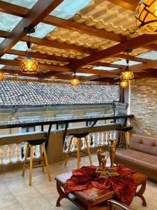 a room with a bar with a table and chairs at Casa Colonial Centro Histórico in Quito
