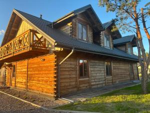 a log cabin with a porch and a deck at Józwówka Swornegacie in Swornegacie