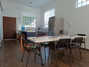 a kitchen with a table with chairs and a refrigerator at Casa Mara in Río Lagartos +21 photos
