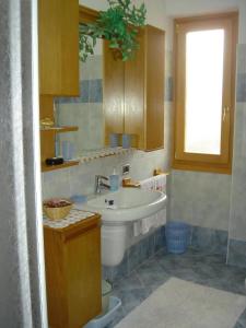 a bathroom with a white sink and a window at 03 Virgilio Zanetti in San Zeno di Montagna +6 photos