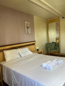 Postel nebo postele na pokoji v ubytování M&V Flats - Prédio Let's Idea- 1 km Mané Garrincha - 500m Esplanada dos Ministérios - Ar condicionado - Cama queen size - Piscina - Academia