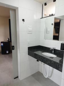 a bathroom with a sink and a mirror at Casa de Praia Família Próximo ao ExpoCentro BC in Balneário Camboriú +37 photos