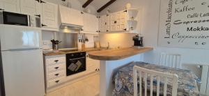 a kitchen with white cabinets and a counter top at Casa Bella Vista in Moraira