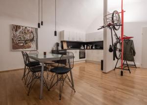 a dining room with a table and chairs and a kitchen at Studio 12 in Linz