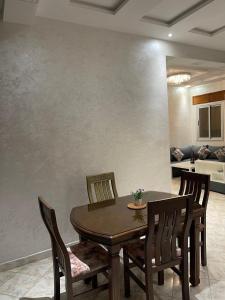 a dining room with a wooden table and chairs at Luxurious apartment in Chefchaouene +4 photos