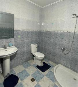 a bathroom with a toilet and a sink and a tub at Luxurious apartment in Chefchaouene