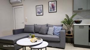a living room with a couch and a table at Kos Cozy Home in Kos