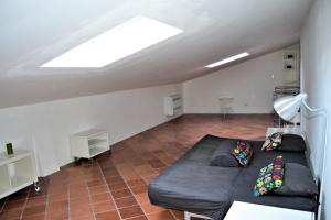 a living room with a couch and a skylight at Le Soleil in Campo nell'Elba