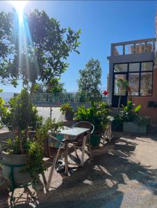 a patio with tables and chairs and potted plants at Hôtel Imouzzer in Ourika +5 photos