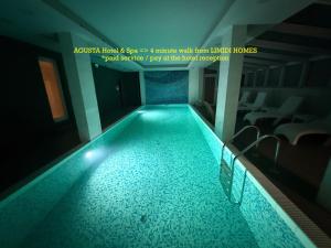 a swimming pool in a building with a room at LIMIDI HOMES - Spacious 2-Bedroom City Centre in Veliko Tŭrnovo