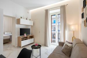 a living room with a couch and a tv at Maison38GuestHouse in Castellammare di Stabia