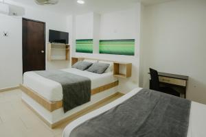 Postel nebo postele na pokoji v ubytování Hotel Plataneras Plaza