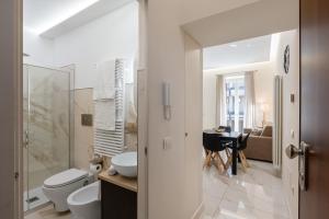a bathroom with a toilet and a sink and a table at Maison38GuestHouse in Castellammare di Stabia +36 photos