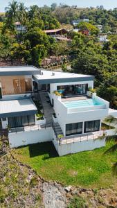 an aerial view of a house with a swimming pool at St Michaels Ocean View House in El Zonte